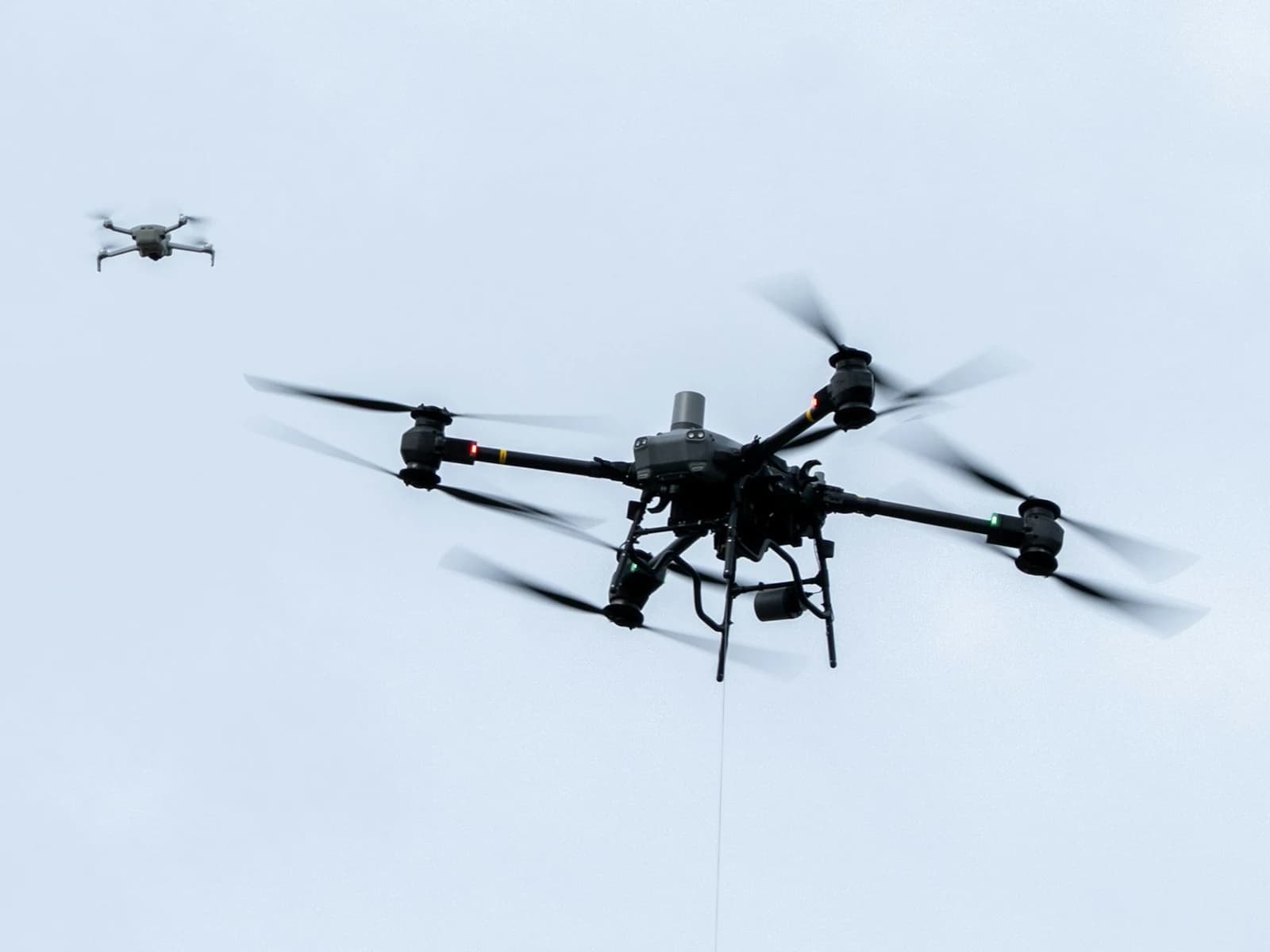 Two aircraft airborne in the same frame, one near and one far.